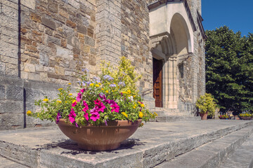 Flower pots at the entrance to the Church of San Salvatore in Castellina in Chianti, Tuscany Italy