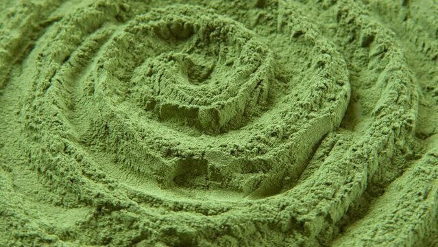 Chlorella or spirulina algae green powder is spinning, rotation. Dietary supplement to improve health. Seaweed super food. Healthy food background. Vitamins and minerals to diet. Detox. Closeup video