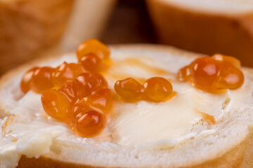 Thinly sliced baguette with salmon caviar and butter