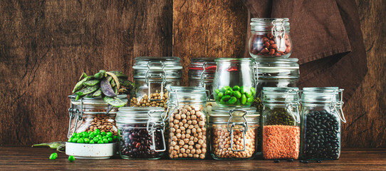 Dried, raw and fresh legumes and beans in glass jars. Lentils, chickpeas, mung beans, soybeans....
