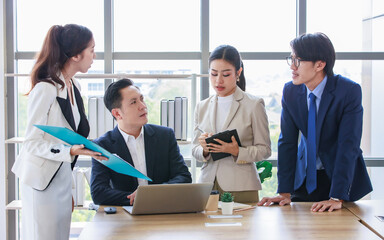 Group of Asian stressed depressed worried tired professional successful female businesswomen and male businessmen employees in formal business suit arguing disagreement about strategy in meeting room