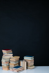 a stack of books on a black background in the library in the office