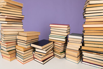 a stack of books on a purple background in the library in the office