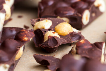 Pieces of homemade milk chocolate with lots of hazelnuts