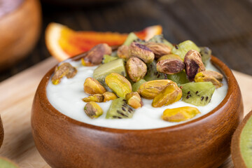 delicious green yogurt with fruit and berry flavor and pistachios