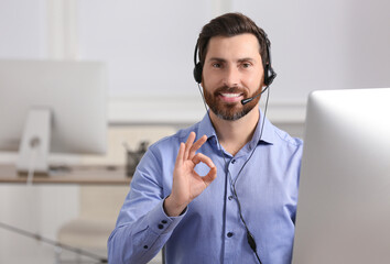 Hotline operator with headset showing OK gesture in office, space for text