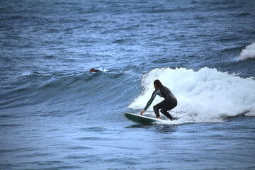 Female surfer in the waves of the Atlantic Ocean, Tenerife, Spain - 598548787