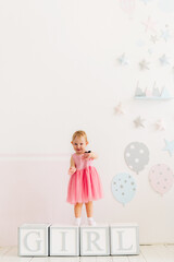 concept of children's emotions. Portrait of lovely toddler little baby child with pink dress	