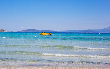 Yellow car boat in the blue sea, holiday travel concept