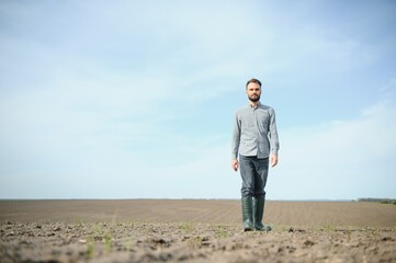 Portrait of farmer standing in field.