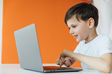 education online online games boy sits at the computer in the office