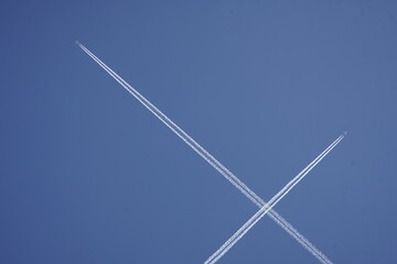 Contrails from two crossing passenger planes over Hanover, Germany.