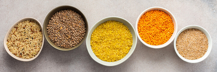 Various grain cereals in bowls banner, top view