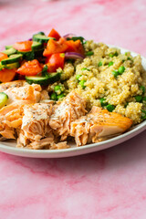 Healthy lunches, quinoa with green peas, with baked red fish salmon and fresh salad of tomato, cucumber and greens