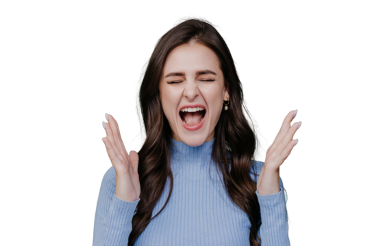 Loud screaming brunette angry girl in lilac sweater eyes closed with opened moth shouting rises hands up. Beautiful hispanic young woman annoyed, frustrated, scared over transparent background
