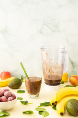 Healthy breakfasts, healthy delicious smoothie with frozen strawberries and bananas and avocado, pea protein and mixed greens, smoothie jar mixer