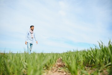 worry less ,indian farmer standing in his healthy wheat field