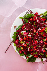 Healthy breakfasts or lunches, baked chickpeas and beetroot salad with goat cheese, mix of herbs and different seeds, top view, copy space