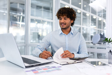 Fototapeta na wymiar Cheerful and successful hispanic businessman on paper work, man signing invoices and contracts, young boss manager at workplace with reports.