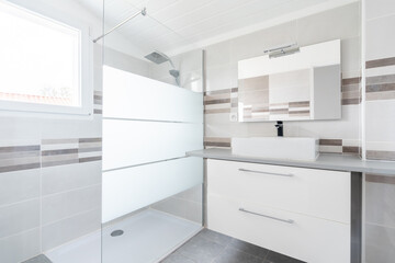 Home bathroom, bright new bathroom interior with tiled glass shower, vanity cabinet, interior designed white and brown