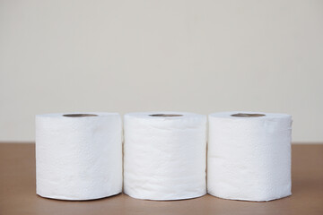 Three rolls of soft white toilet tissue paper. Concept, hygienic and sanitary materials for after using toilet or bathroom. Useful and versatile for cleaning and wiping.                            