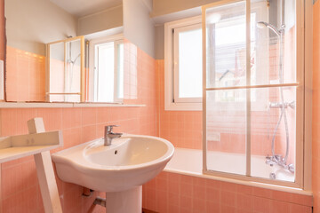 Home bathroom, bright new bathroom interior with tiled glass shower, vanity cabinet, interior designed white and pink