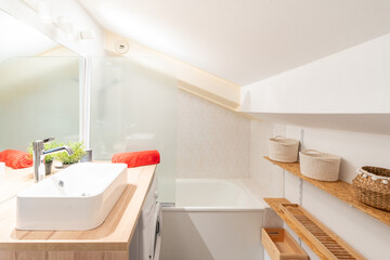 Home bathroom, bright new bathroom interior with tiled glass shower, vanity cabinet, white designed interior with storage baskets