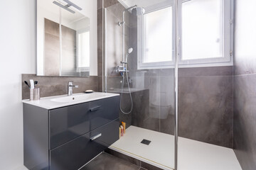 Home bathroom, bright new bathroom interior with tiled glass shower, vanity cabinet, interior...