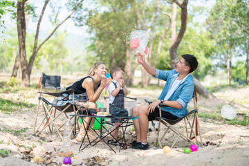 Obraz premium Family enjoying a camping holiday in the countryside ,Camping, travel, tourism, hiking and people. Concept - Happy family with backpacks and thermos at camp.