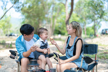 Obraz premium Family enjoying a camping holiday in the countryside ,Camping, travel, tourism, hiking and people. Concept - Happy family with backpacks and thermos at camp.