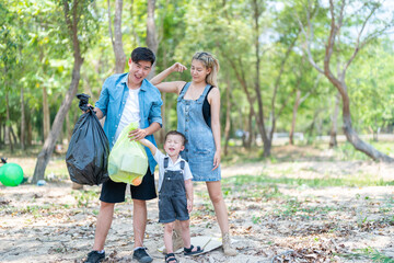 Asian family picking up trash in the forest. Litter cleanup activities. Environment protection. recycling.