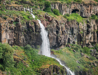 The waterfall descends between the rocks. in Armenia.