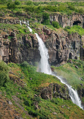 The waterfall descends between the rocks. in Armenia.