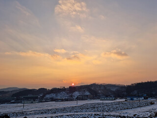 Rural winter landscape at sunset