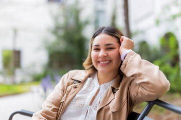 Fototapeta premium Young woman smiling sitting in a bank
