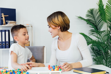 a child psychologist is engaged with a child in the office