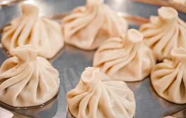 Khinkali cooked on metal platter, selective focus