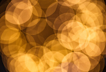 Glare of light around blurred yellow, abstract background