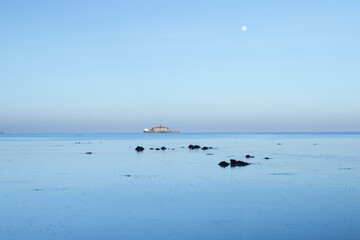 An old fort in the calm sea at twilight