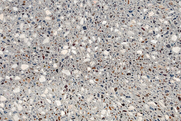 Background cement wall interspersed with multicolored rubble and marble chips, uniform texture background