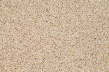 Fototapeta na wymiar Background, sand, sandy surface uniform texture pattern, grains of sand close-up
