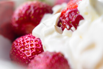 Fresh delicious berries of strawberry with sour cream and sugar, blurred, with shallow depth of field