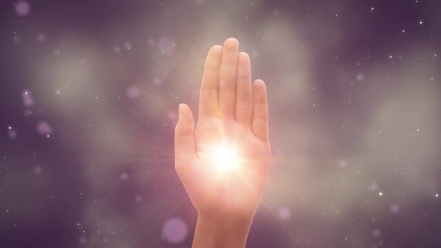 Visualization Of Male Or Female Hand Reaching Out To Show Hamsa Religious Gesture on Dark Purple Background. Bright Light Appearing In The Middle Of Palm. Traditional Protection Sign Concept.