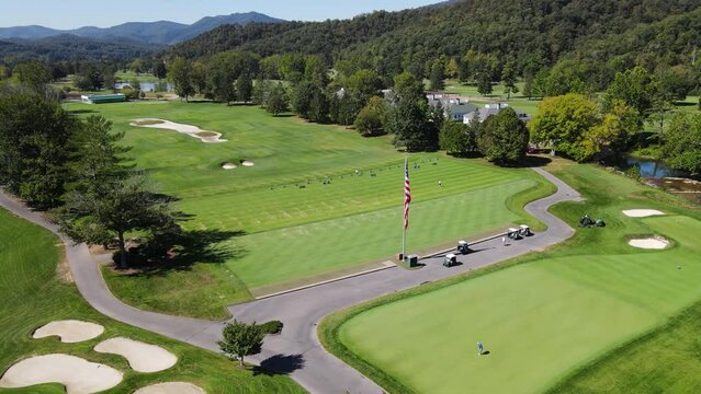 Aerial rotating parallax shot of golf driving range at the Greenbrier Resort during summer.