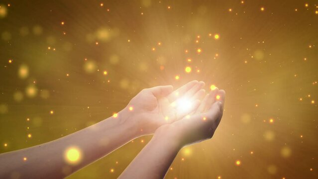 Conceptual Visualization Of Male Or Female Hands Reaching Out In Prayer On Magical Dark Yellow Background. Person Connecting With Higher Spiritual Energy Through Bright Light In Their Palms.
