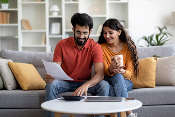 Indian Married Couple Planning Budget Together, Reading Papers And Calculating Spends Generative AI - obrazy, fototapety, plakaty