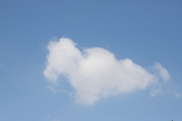Naklejka na ściany i meble White clouds against the blue sky.