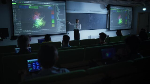Young Female Teacher Giving a Data Science Lecture to Diverse Multiethnic Group of Female and Male Students in Dark College Room. Projecting Slideshow with Neural Network Model