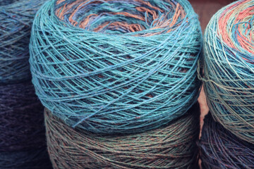 Round skeins of organic multi-coloured lambswool yarn.