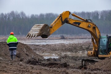 Ust-Luga, Leningrad oblast, Russia - November 16, 2021: Worker controls the excavator working....